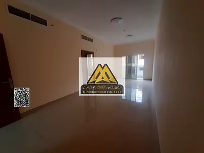 First-tenant apartment in Al Jurf 3, Ajman, one bedroom and living room, master bedroom, 2 bathrooms, balcony with open view, central AC, built-in war