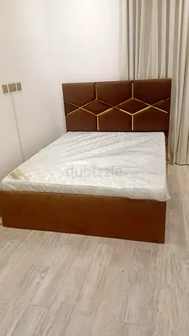 Brown upholstered double bed with mattress