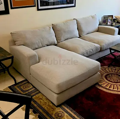 Light beige three-seater L-shaped sofa