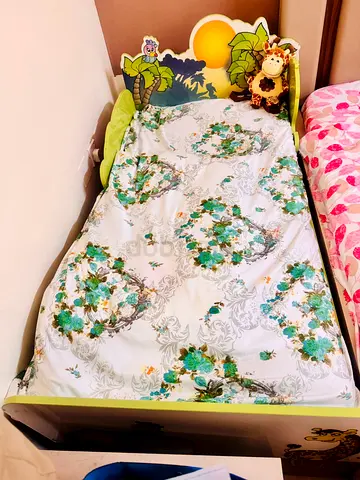 Kids bed with themed headboard and bedding from Home Center can be used up to 10 years