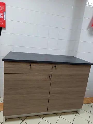 Compact two-door storage cabinet with dark top