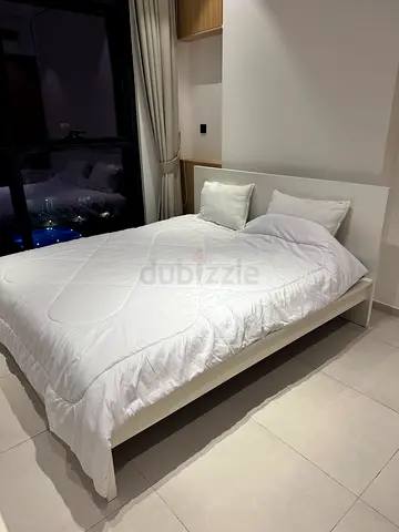 Simple white ikea malm double bed frame with mattress and