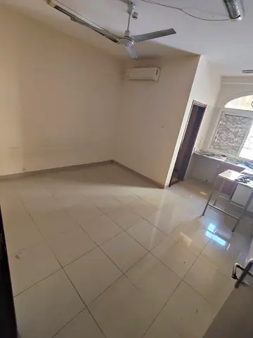 For rent: large studio in Al Ghuwair near MNC Hospital. Prime location, family-friendly, split AC, spacious layout. Rent AED 15,000/year, 4 payments.