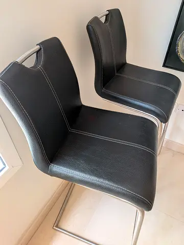 Pair of black leather bar stools with metal frame. 90 per piece