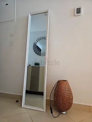 Full-length Wall Mirror with White Ornate Frame and a Lamp