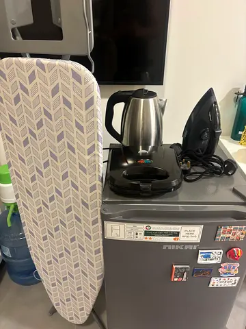 Ironing board with steamed iron and kettle - used, sandwich maker and fridge