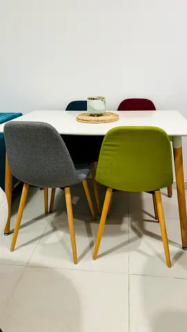 White Dining Table with 4 Multi-Colored Fabric Chairs