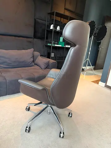 Used ergonomic leather office chair on wheels — good condition