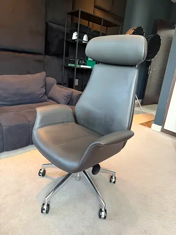 Used ergonomic leather office chair on wheels — good condition
