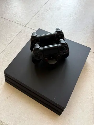 Sony PlayStation 4 Pro with 2 DualShock 4 Controllers - Good Condition