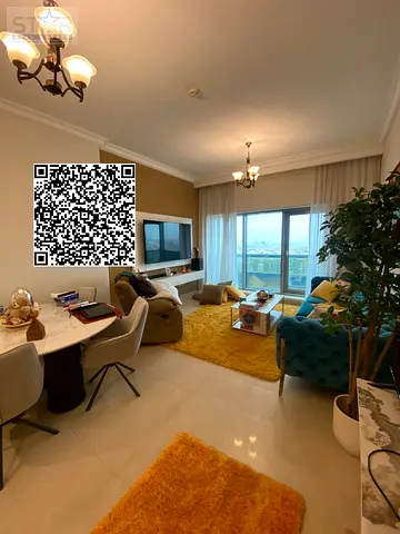 A spacious apartment with easy access to Sharjah and Dubai, close to amenities, in a luxurious tower.