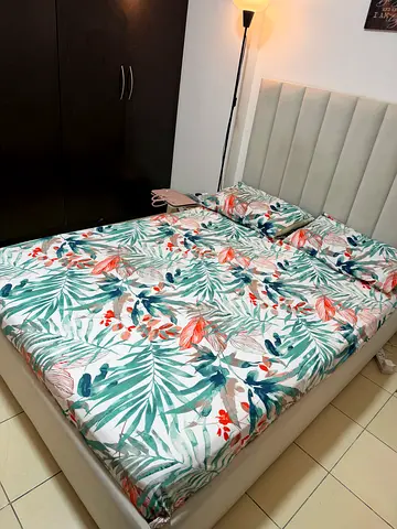 Queen upholstered bed frame with mattress — neutral beige