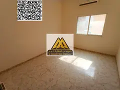 A spacious studio for annual rent in Al Rawda 3 – Ajman, featuring a separate kitchen and split AC