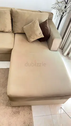 Beige L-shaped Sofa with cushions  table