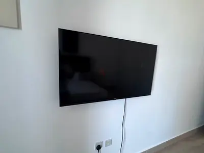 Wall-mounted LED TV in good condition