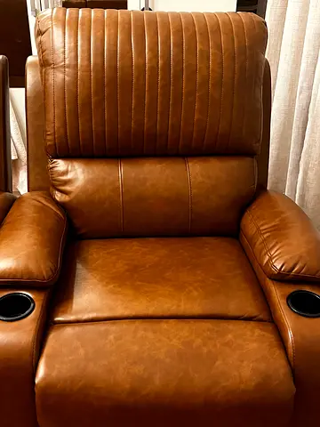 Brown one-seater leather recliner with cup holders and an extender. Almost new. Price per piece