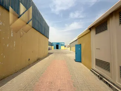 Prime yard in Industrial Area 18 on a main road, 10,000 sq. ft. with offices and a warehouse, ready for operation at a great price