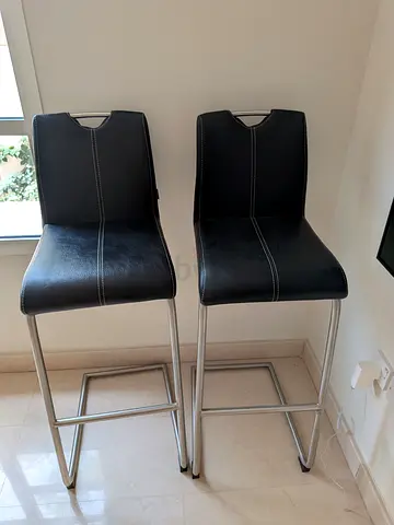 Pair of black leather bar stools with metal frame. 100 per stool.