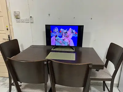 Dark wood dining table with four chairs - good condition