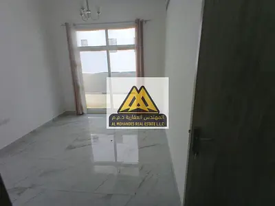 One-bedroom apartment for rent in Al Jurf 3 with a balcony, two bathrooms, and central air conditioning, near the Chinese market, at a special price.