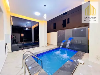 A stunning villa with a swimming pool, featuring 6 master bedrooms with built-in wardrobes and a de