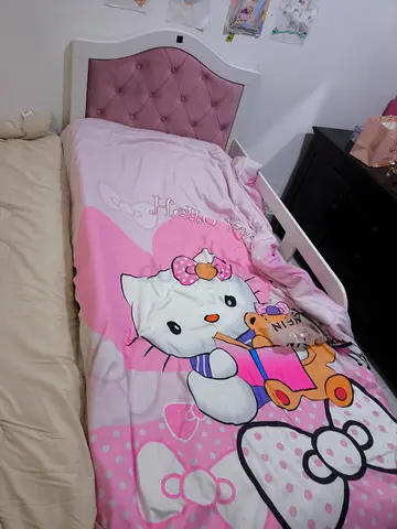 Girls single toddler bed with pink upholstered headboard