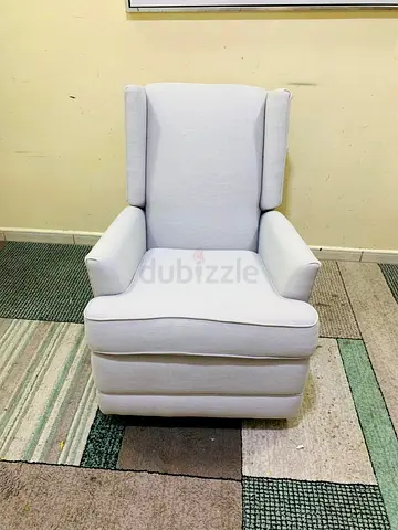 Light grey upholstered wingback armchair — good condition