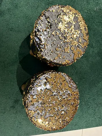 Pair of small round sequin-covered stools with wooden legs
