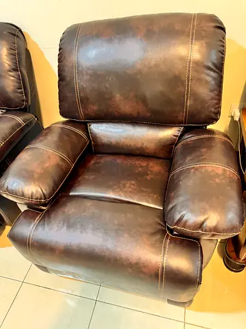 Brown faux leather reclining armchair — good condition swings back and forth