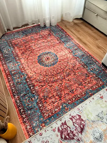 Used Persian-style area rug - warm rust and blue tones, 150x220cm