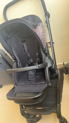 Good-condition black single stroller with reclining seat and safety harness