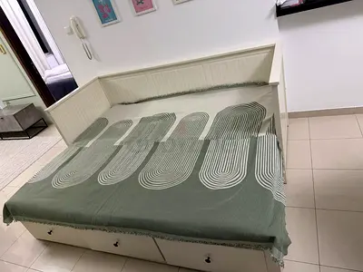 Ikea White Daybed with Storage Drawers and Green Geometric Throw