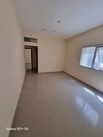 For rent in Bu Tina: 1BR + hall, 2 baths, central AC, spacious layout, modern design, prime locatio