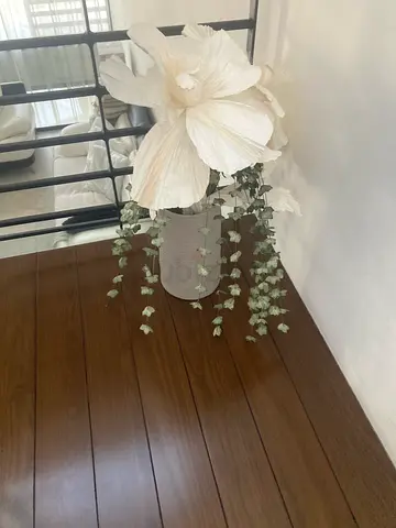 Decorative white faux flower arrangement in grey vase