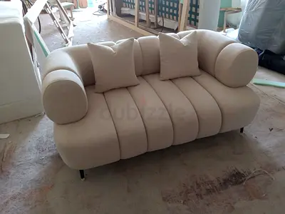 Beige Two-Seater Curved Modern Sofa with Cushions