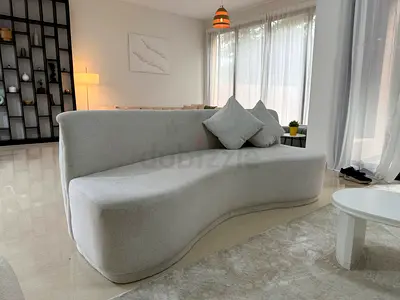 Curved Beige Sofa + 2 Cushions — Modern Designer Piece