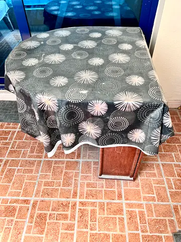 Outdoor Solid wooden oval dining table with protective cover — good condition with two wooden chairs