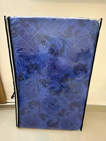 Single Foldable mattress in blue patterned cover - lightly used