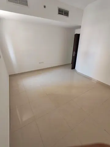 Annual rent in Sharjah, Al Taawun area, two bedrooms, a living room, and a hall.