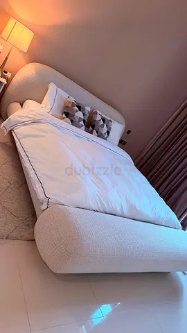 Modern curved upholstered superking bed in cream — excellent condition