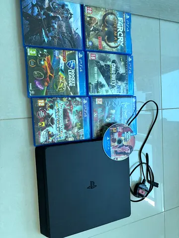 PlayStation 4 Slim console with 7 PS4 games and power - Working
