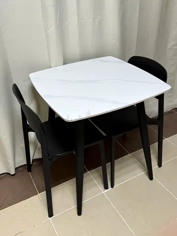 Compact white marble-effect dining table with 2 black chairs - like new