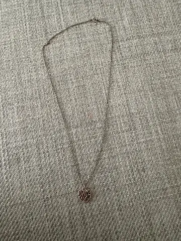 Silver filigree pendant necklace — delicate chain with circular locket