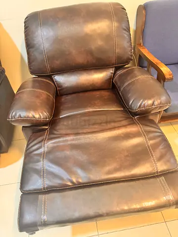 Brown faux leather reclining armchair — good condition swings back and forth