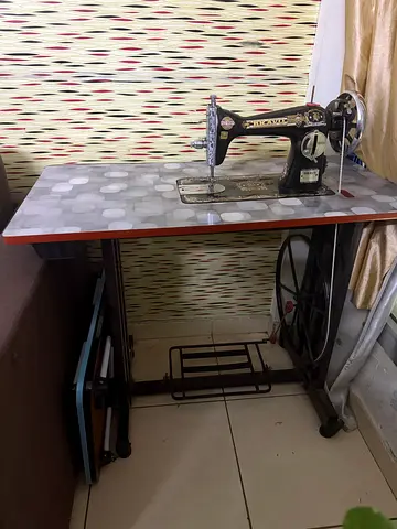 Vintage Foot-Pedal Singer Sewing Machine on Metal Treadle Table and additional motor separately.