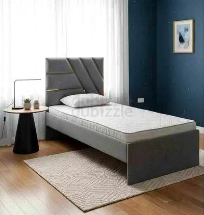 Single grey upholstered bed frame with headboard and mattress