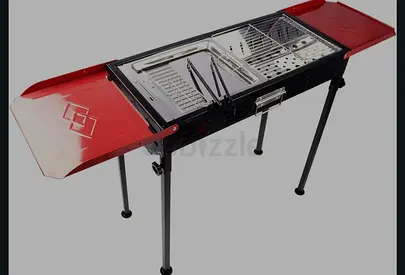 Portable foldable charcoal BBQ grill with side shelves and legs - used