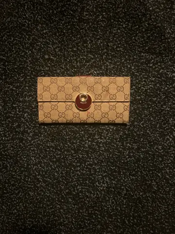 Beige monogram Gucci-style long wallet with snap closure