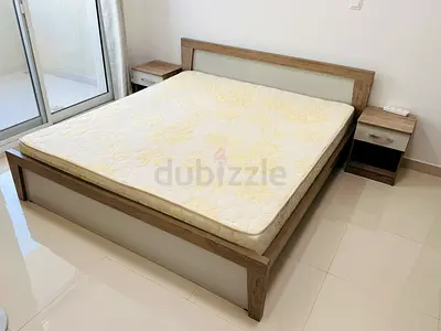 Bed room set with king size bed, two side tables and drawer