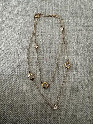 Long gold-tone clover pendant station necklace with crystal accents